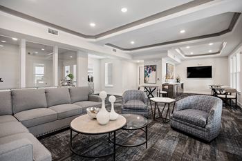 The living room of a new home with couches and chairs